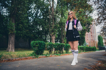 Full length photo of lovely teen lady autumn school shopping sales dressed stylish uniform garment autumn park sunny day background