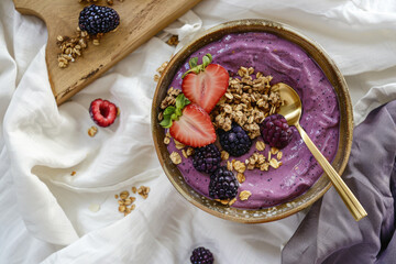 Berry smoothie bowl topped with granola and fresh berries