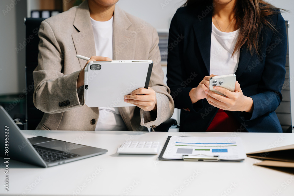 Poster business documents on office table with smart phone and calculator digital tablet and graph business