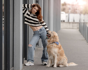 Teen Girl Poses With Golden Retriever Near Store In Spring