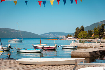 Beautiful sunny view of village pier with boats on the Mediterranean coast. Summer vacation at resort - Powered by Adobe