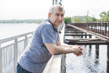 Mature European man with a good mood, outdoor portrait. The concept of life after 50 years	