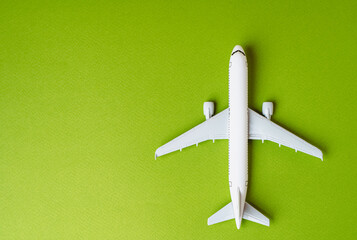 Passenger plane on a green background and space for text. Environmentally friendly fuel....