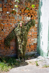 volunteer woman in a camouflage suit made of multi-colored threads, handmade, help to the military, Ukraine