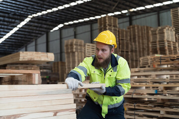 Male worker working in wooden warehouse storage. Male construction worker working at wooden...