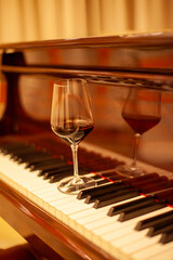 Red wine glass on piano