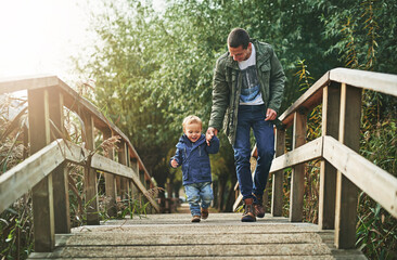 Walking, bridge and father holding hands with child for playing, explore and adventure for fun...