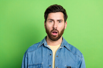 Obraz premium Photo of cheerful impressed guy dressed jeans shirt open mouth empty space isolated green color background