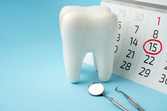 Dentist appointment calendar on a blue background with copy space