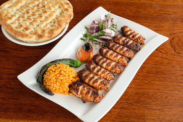 A close-up photo of a plate of grilled chicken wings with appetizers