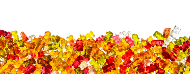A panorama, banner, border of different colored gummy bears in front of a white background