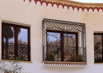 Reflection of the Alcazaba, a medieval fortress, in the windows, Almeria, Spain
