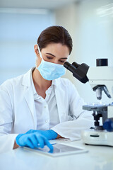 Scientist, microscope and woman in lab with tablet for medical study, analysis and stem cell...