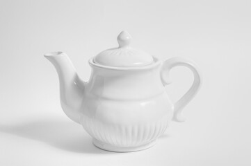 White teapot, isolated on white background. high key black and white photography