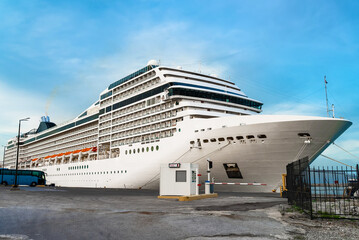 A large white cruise ship awaits passengers at the port.
