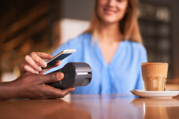 Phone, payment and customer POS in cafe or coffee shop with easy fintech machine for shopping....