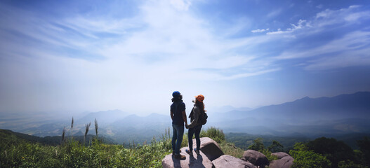 Lover women and men asians travel relax in the holiday. Stand up landscape on the Moutain. Mountain Park happily. In Thailand