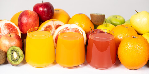 Different fruit juices in glasses on white background, long banner