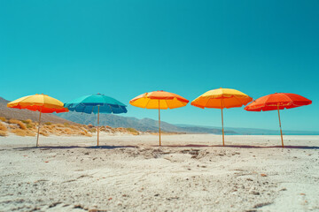 A surreal depiction of oversized, brightly colored umbrellas floating above a deserted sandy beach under a clear blue sky,