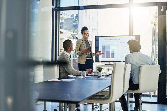 Business woman, coach and screen with team for meeting, presentation or corporate discussion on revenue at office. Female person talking to employees with graph, chart or data for profit at workplace