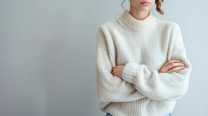 Woman in Cozy White Knit Sweater with Folded Arms