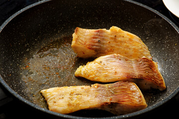 Carp fish steak on frying pan