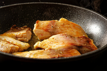 Carp fish steak on frying pan