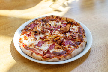 Fresh Baked Meat Lover's Pizza on Wooden Table