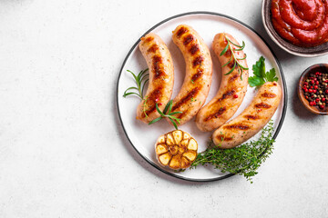 Grilled sausages with tomato sauce and herbs