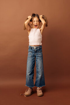Little girl screaming and pulling her hair