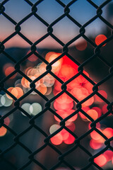 blurry traffic lights through fence