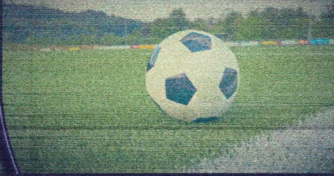 Soccer VHS - Soccer ball lying next to one of the line markings of a soccer field. Retro style. Damaged VHS tape. Faulty VCR. Faulty TV set. Electromagnetic interference - VFX