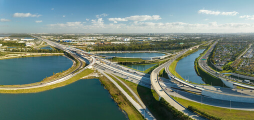 Above view of wide highway crossroads in Miami, Florida with fast driving cars. USA transportation...