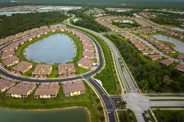 Aerial view of tightly located family houses in Florida closed suburban area. Real estate...