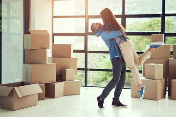 New home, excited and couple hug with box for moving for house, property mortgage and real estate...