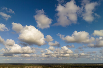 Blue sky with white summer rain clouds. Colorful summer landscape