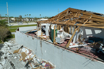 Damaged house roof and walls after hurricane Ian in Florida. Consequences of natural disaster