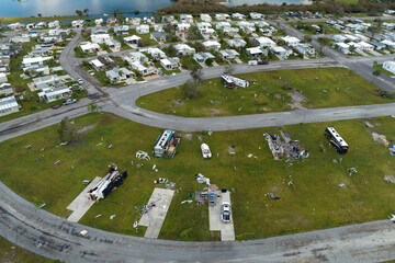 Destroyed RV camper vans and and mobile homes after hurricane in Florida residential area....