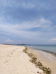 The ocean shore in Bali, clouds in the blue sky, sunny clear day, Bali, Indonesia