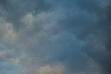 A close-up of a storm cloud, overcast sky, dramatic sky before the rain, shades of light in the...