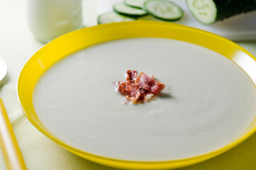 cold cucumber yogurt soup in yellow plate