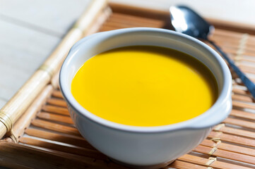 Pumpkin cream in white bowl over Bambu tray
