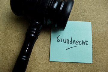 Concept of Grundrecht write on sticky notes isolated on Wooden Table.