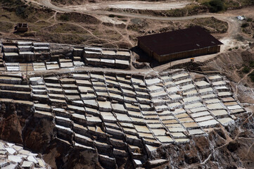 Mountain with salt terraces in the reserve called Salineras de Maras in Peru