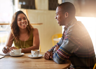 Smile, couple laughing and talking in coffee shop for conversation, morning meeting or bonding together in restaurant. Happy man, woman and relax in cafe with tea cup for chat, news or funny story