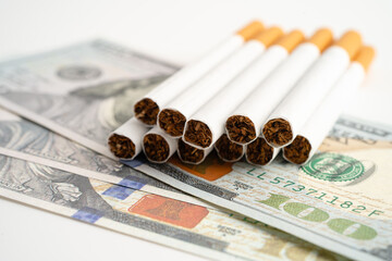 Cigarette on US dollar banknotes, cost, trading, marketing and production, No smoking.