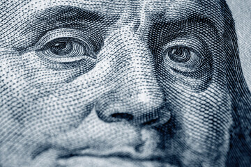 Macro image of Benjamin Franklin on the one hundred US Dollar bill. Selective focus on eyes.