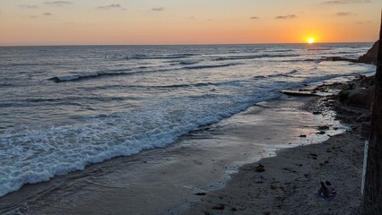 Southern California beach scenes with sunsets, surfers, tide pools, rocks and palms trees in...