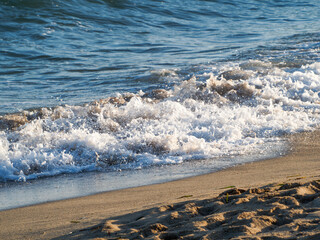 Photo on the surface of crashed waves on the beach of the coast. Tropical surf on the beach. waves...
