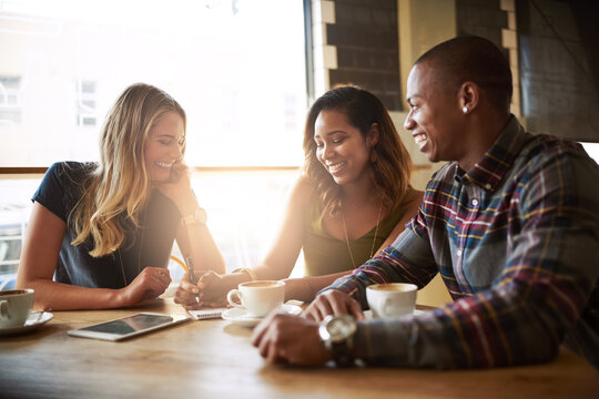Smile, students and friends in coffee shop for talking, conversation or studying together in restaurant. Happy people, group and relax in cafe at university for learning, laughing or writing notes